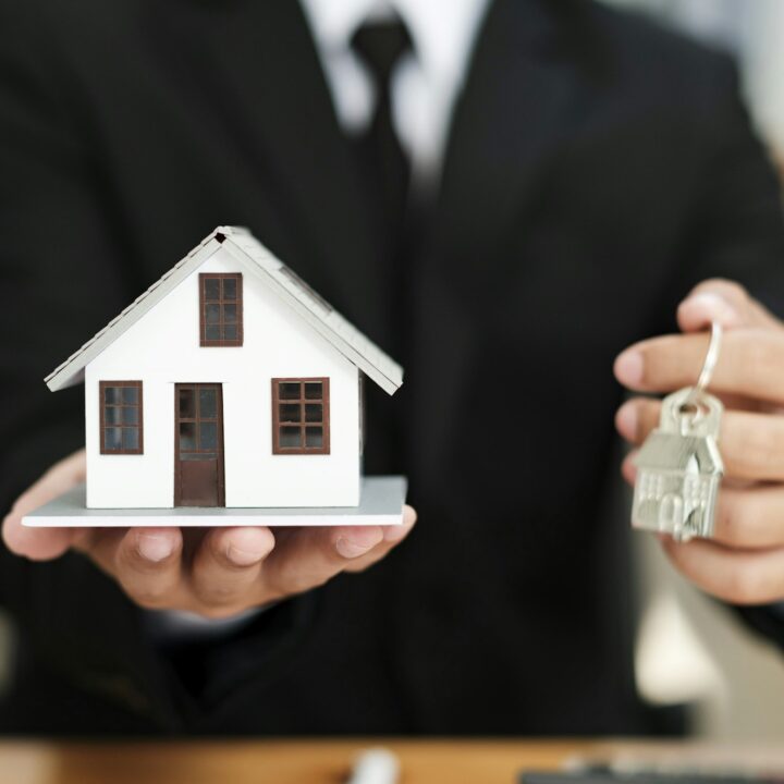 Businessman Holding House Keys